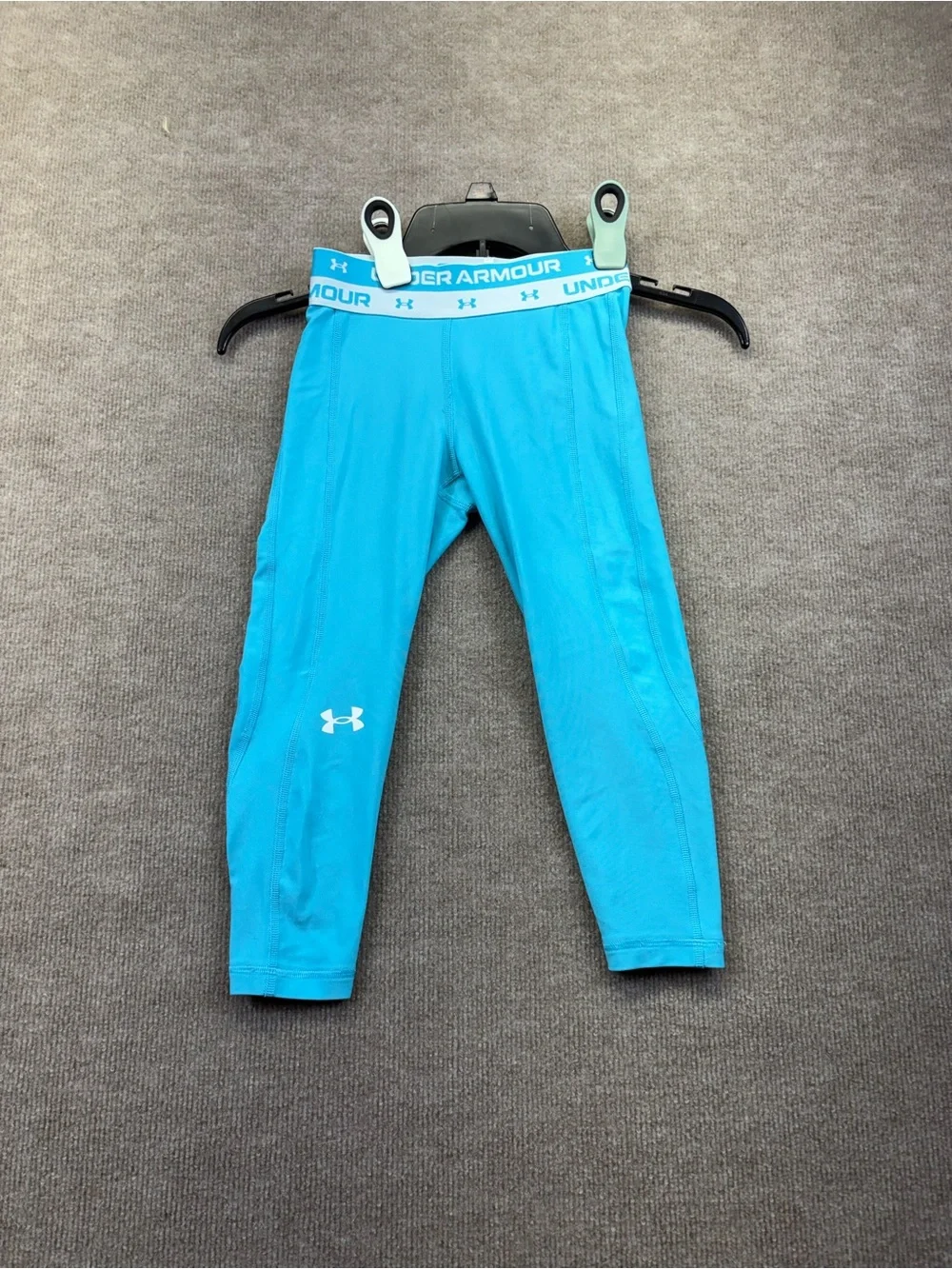 Under Armour YS are a teal blue with a logo elastic waistband